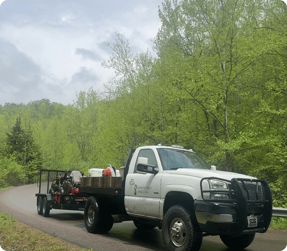 Utility truck driving through lush greenery